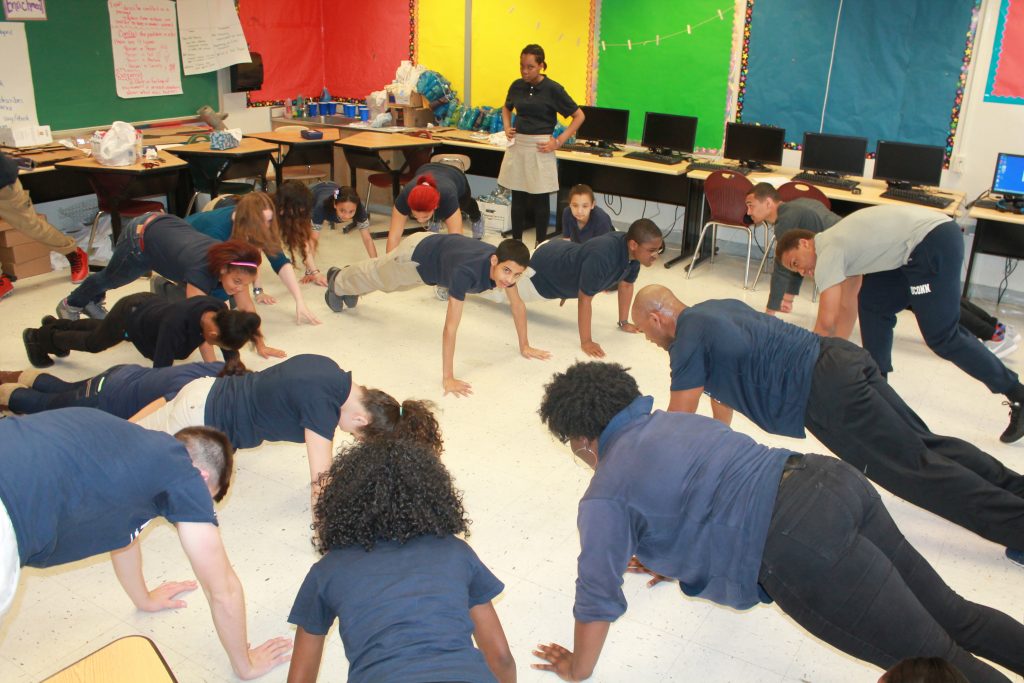 Husky Sport students in a Classroom doing Push-ups